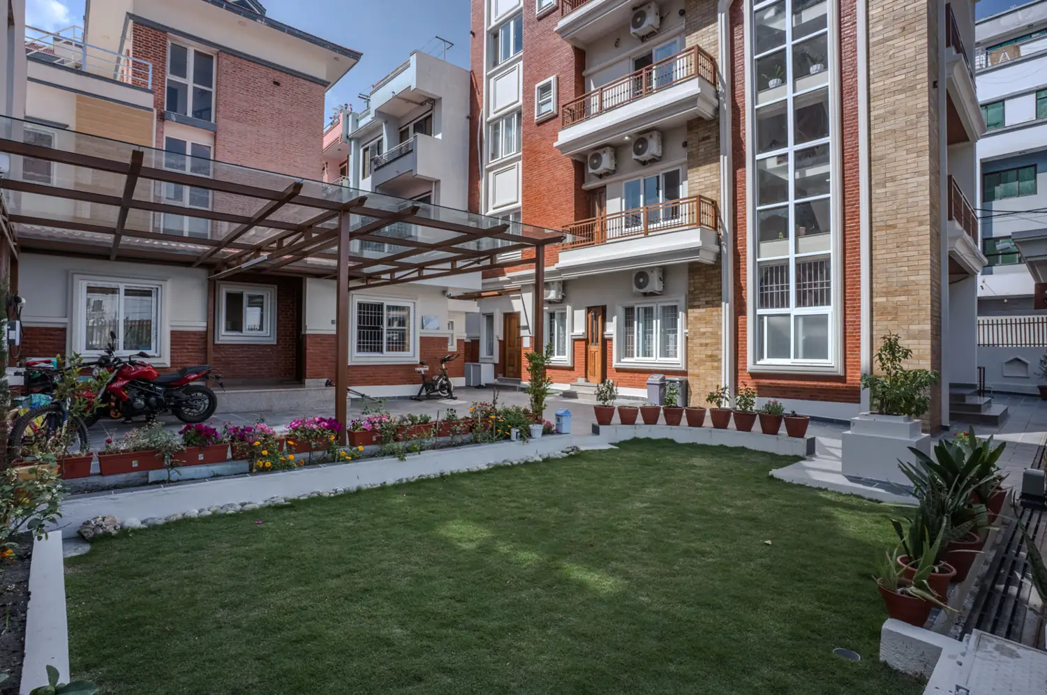Lawn garden with flower beds beside the building